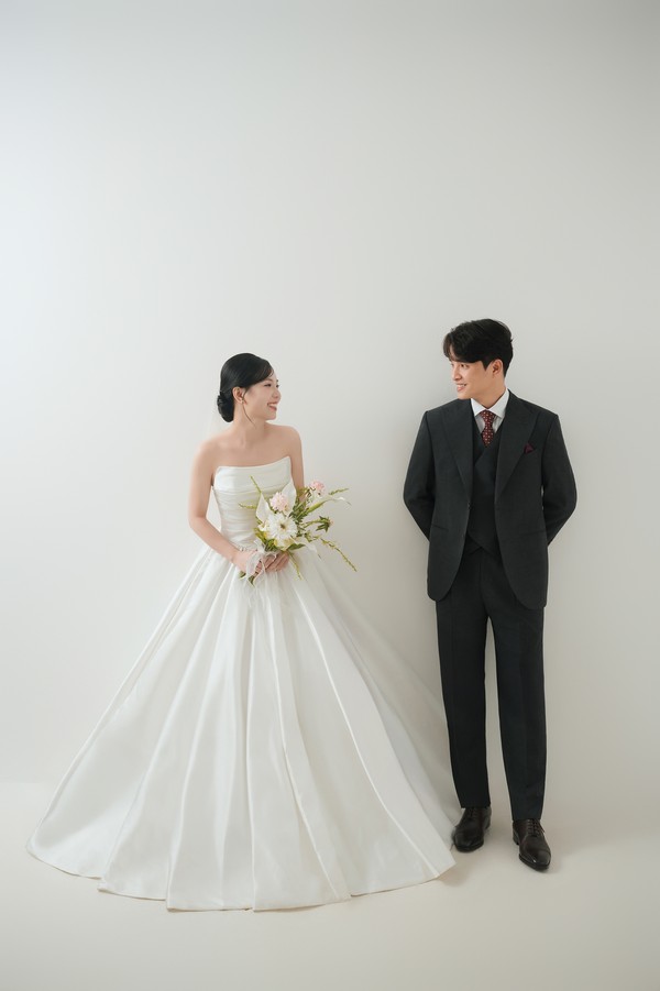 Cặp đôi đứng trang trọng trên nền phông trắng studio