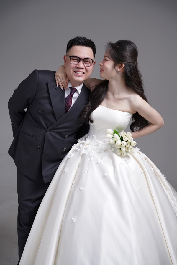 Chú rể Vũ Xuân Giang tạo dáng trang trọng bên cô dâu diện váy cưới bồng bềnh